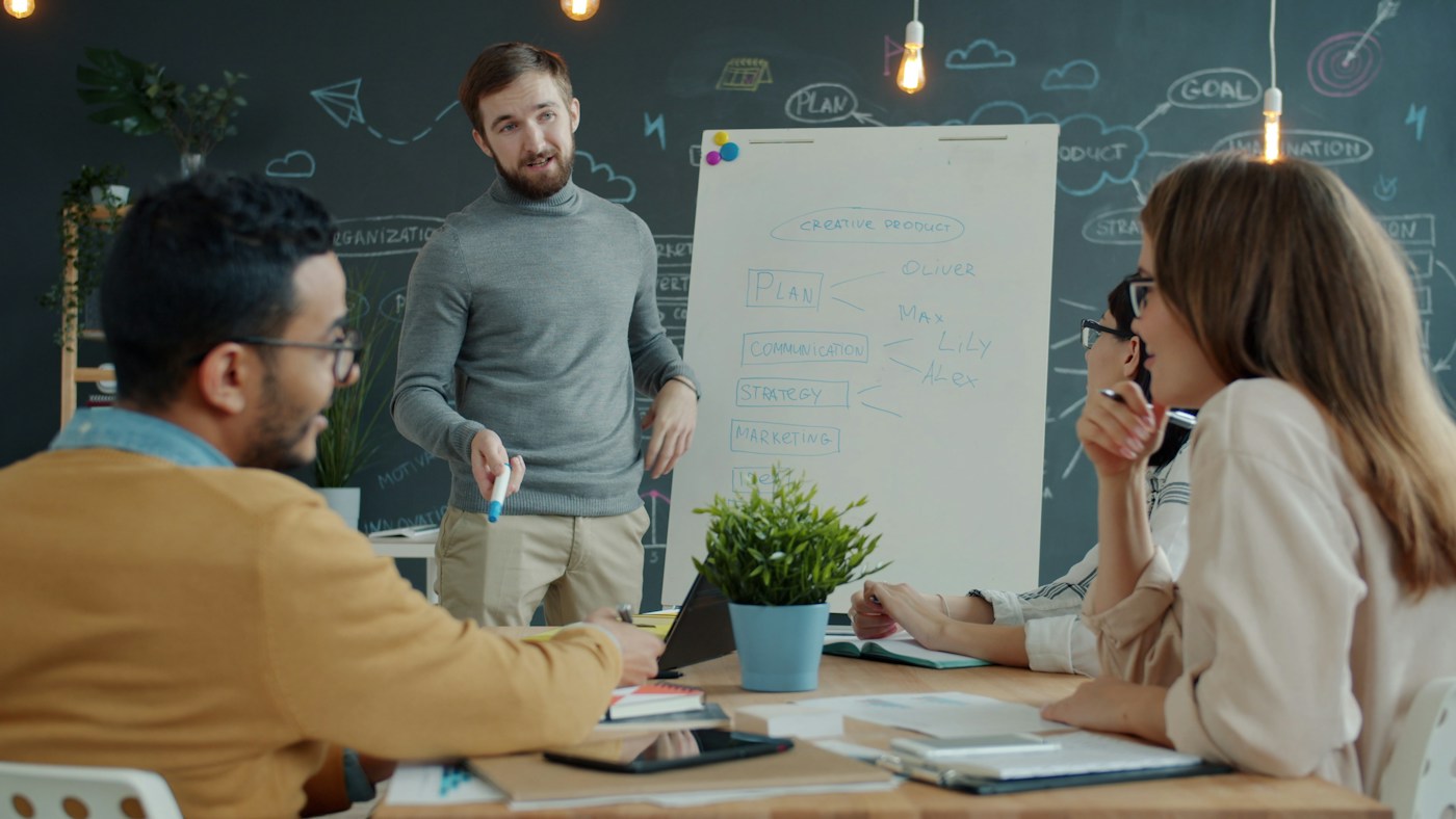 Team discussing strategy at a whiteboard